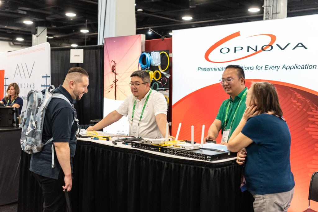 Exhibitors standing at their booth